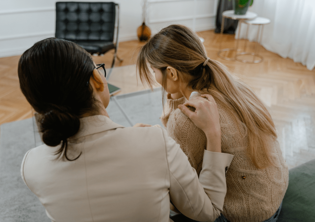 Femme écoutant et soutenant une autre femme victime de harcelement au travail